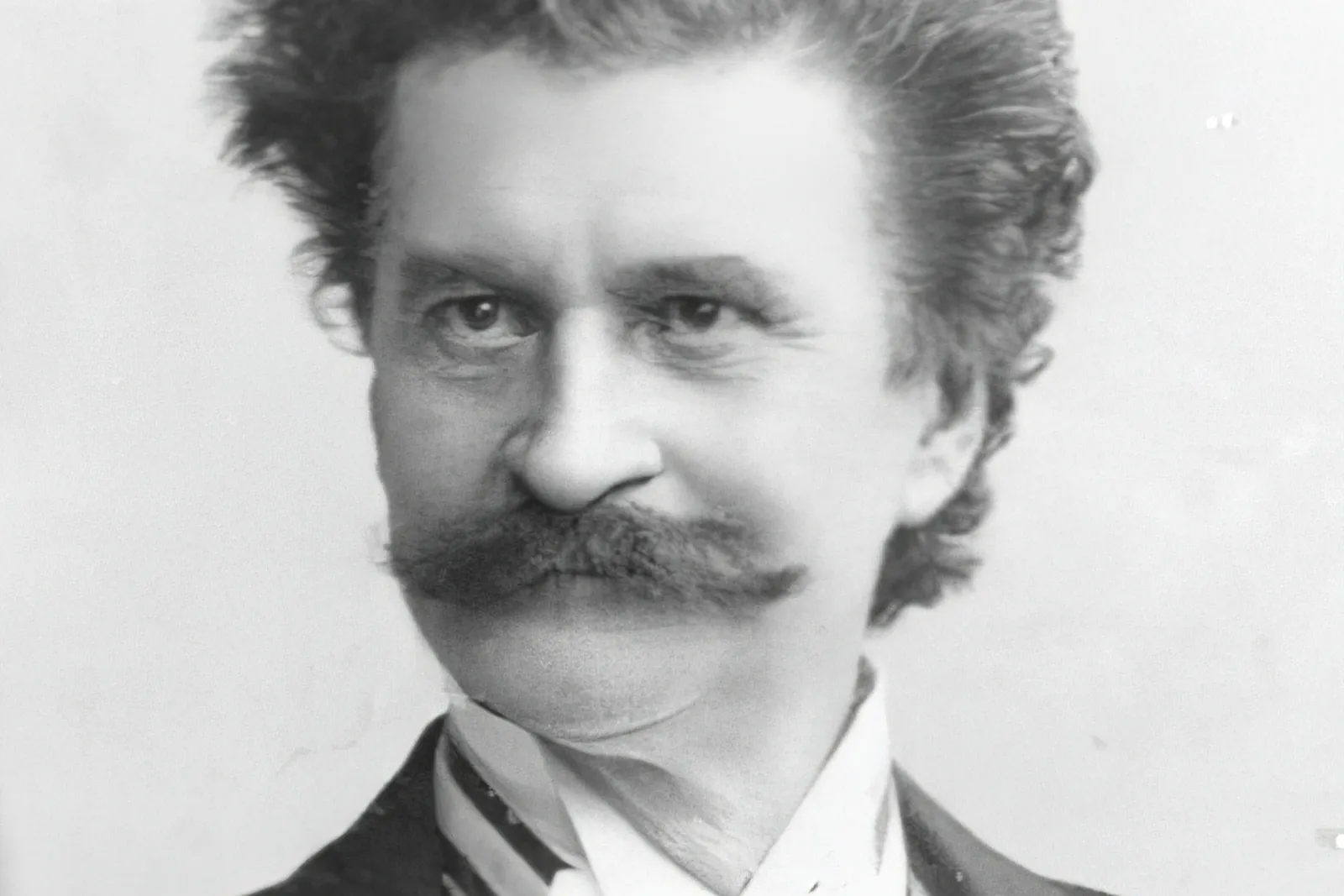 Portrait photograph of Johann Strauss II, the Waltz King, with swept-up hair and a large moustache